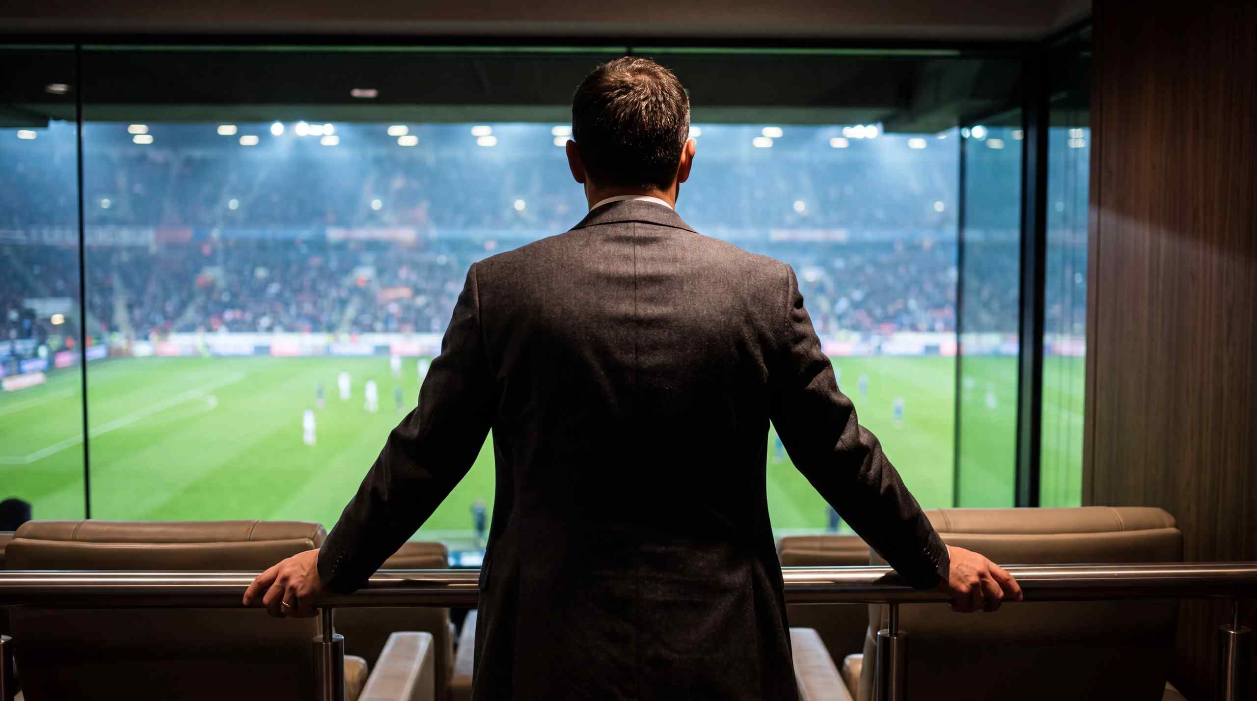 An executive in a suite observing sports.